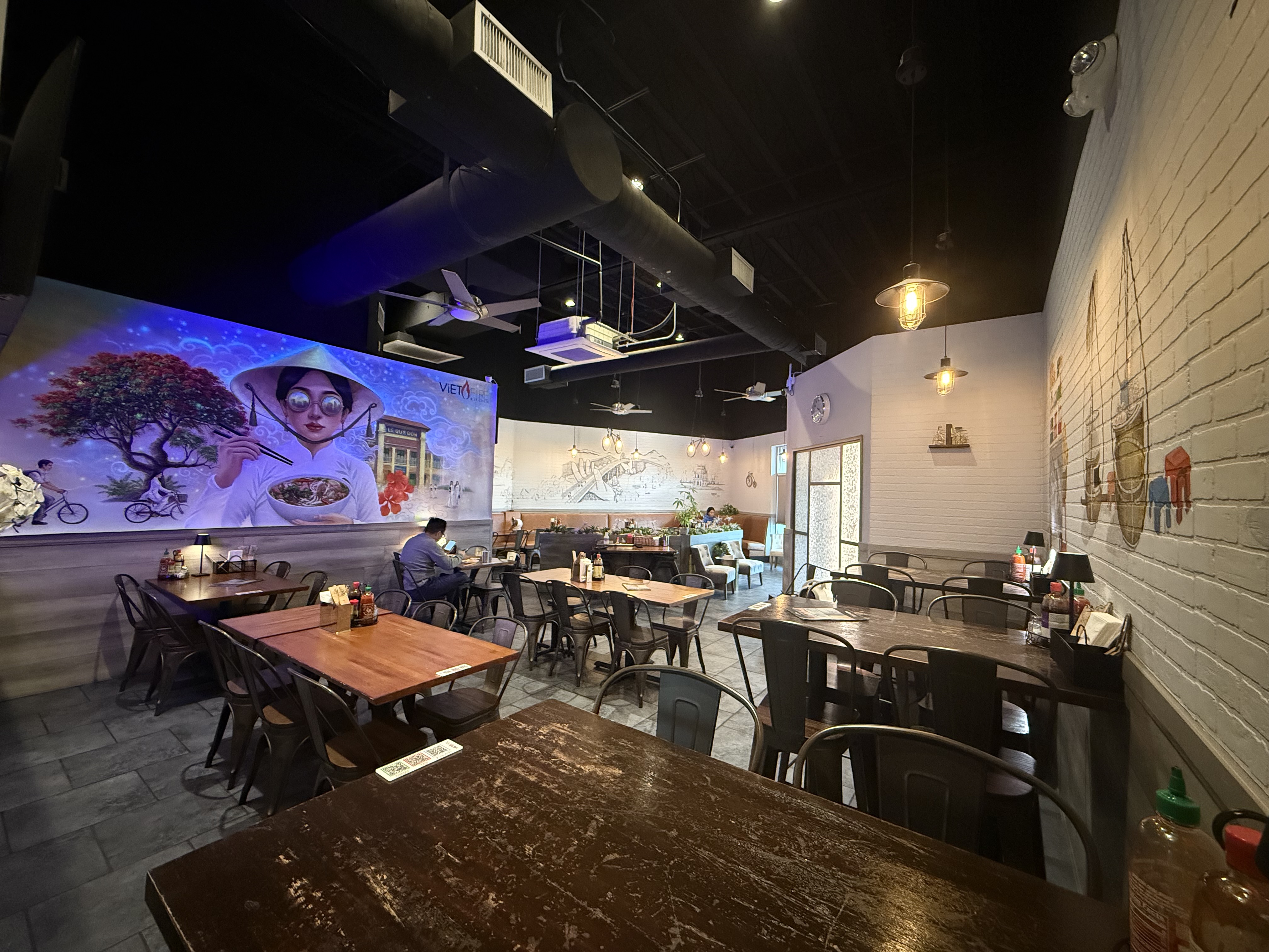 Viet Fire Kitchen dining area featuring motorcycle mural and Viet Street map art